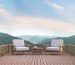 Wood balcony with mountain view 3d rendering image. There are wood floor.Furnished with fabric and wooden furniture. There are wooden railing overlooking the surrounding nature and mountain